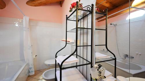a bathroom with a toilet and a glass shower at Villa Isella - Mansarda in Carlazzo