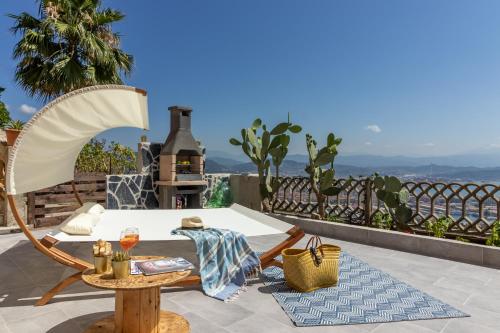 a patio with a table and a chair on a balcony at Golden View Holidays in La Spezia