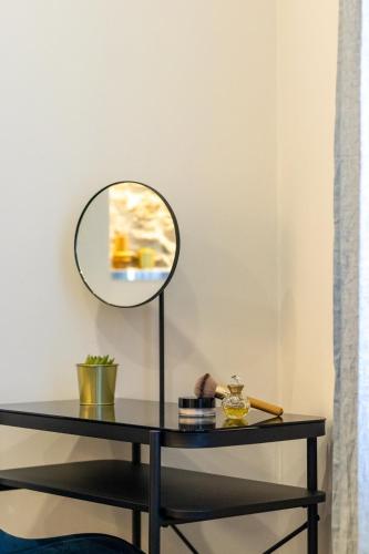 a table with a mirror on top of it at Golden View Holidays in La Spezia