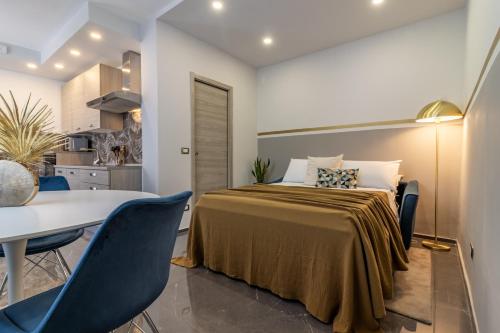 a bedroom with a bed and a table and chairs at Golden View Holidays in La Spezia