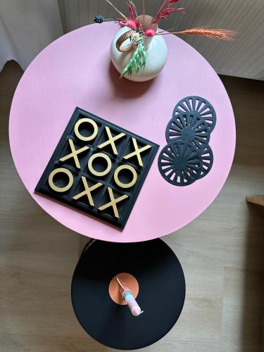 a pink table with a plate of food on it at Hoeve de Binnenplaets Schimmert in Schimmert