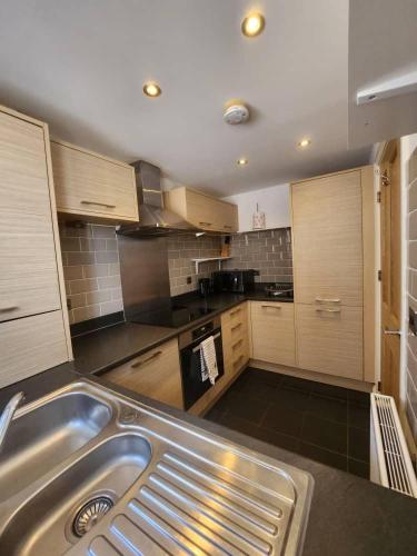 a kitchen with a stainless steel sink in it at 4 Bed House - Sleeps 8 - Wifi - Parking in West Thurrock