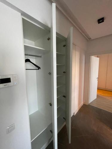 a room with white walls and a walk in closet at Sunrise Apartments - Onix Pipera in Bucharest