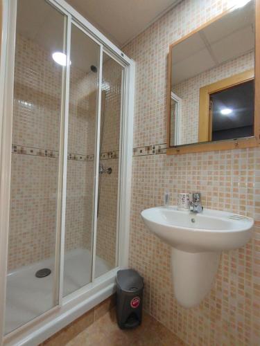 a bathroom with a sink and a shower at Hostal Abastos in Valencia