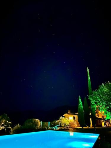 a view of a swimming pool at night at Can Homs in Beuda