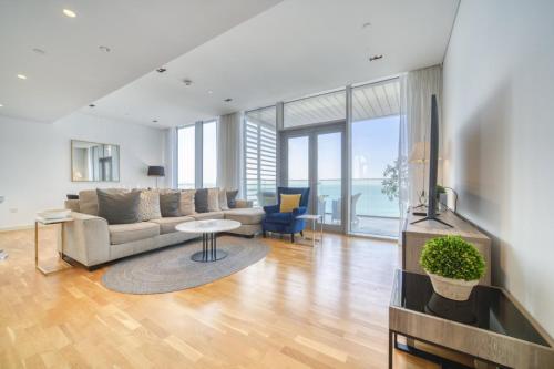 a living room with a couch and a table at Lagom Vacation Home 2 Bedroom Apartment Blue Waters in Dubai
