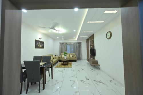 a living room with a table and a couch at The Grace Residence - Unmarried Couples Not Allowed in Manipala