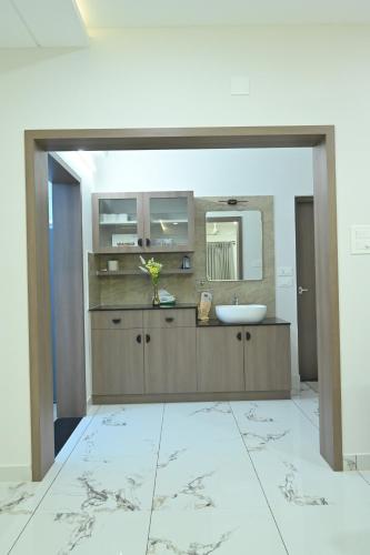 a bathroom with a sink and a mirror at The Grace Residence - Unmarried Couples Not Allowed in Manipala