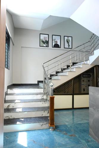a set of stairs in a building with a metal railing at The Grace Residence - Unmarried Couples Not Allowed in Manipala
