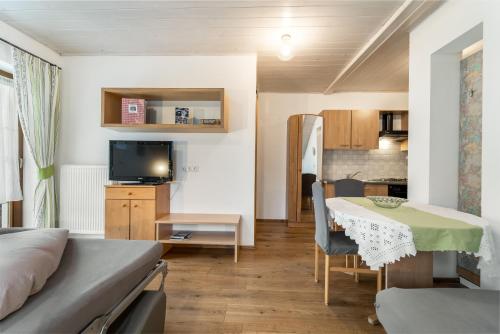 a small apartment with a bed and a table and a kitchen at Holzerhof Lothen , Campolino in San Lorenzo di Sebato