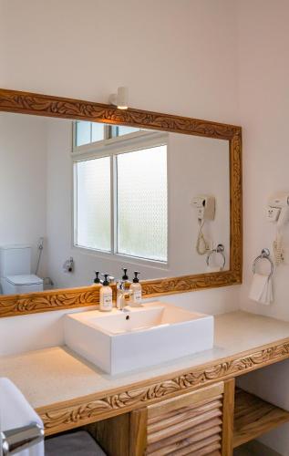 a bathroom with a sink and a mirror at Ocean Boutique Hotel - Adults only in Pingwe