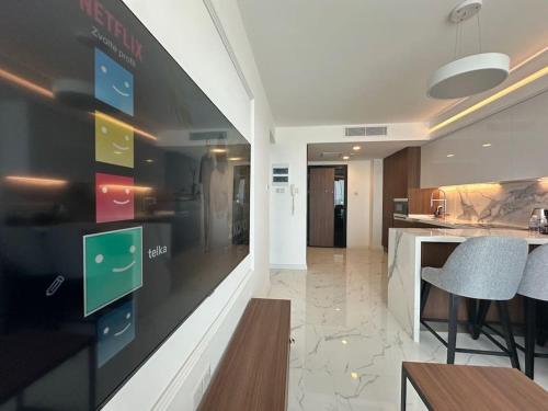 a kitchen with a wall with a display of apps at Grand Sapphire One Bedroom Luxury Residences By MyGuest Cyprus in Iskele
