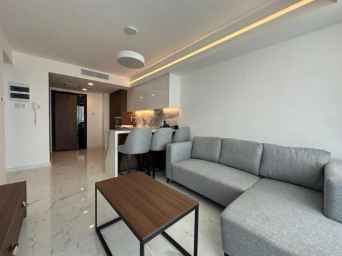 a living room with a couch and a table at Grand Sapphire One Bedroom Luxury Residences By MyGuest Cyprus in Iskele