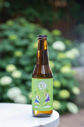 a bottle of beer sitting on a table at Ichiraku tendo spa & brewery in Tendo