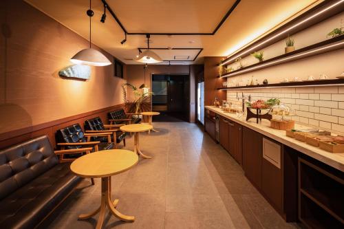 a restaurant with tables and chairs and a bar at Ichiraku tendo spa & brewery in Tendo