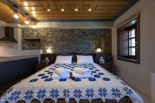 a bedroom with a large bed with two pillows at Tis Ouranias in Koukouli