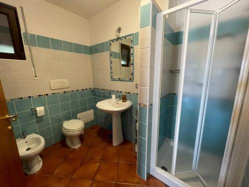 a bathroom with a toilet and a sink and a shower at Villa Sorrentina in Alghero