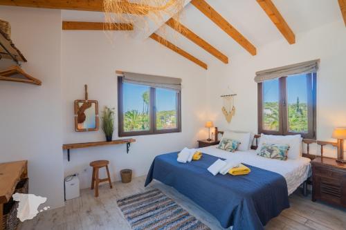 En eller flere senge i et værelse på Villa Safari