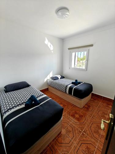a bedroom with two beds and a window at Beautiful House Delta Ebro in Camarles