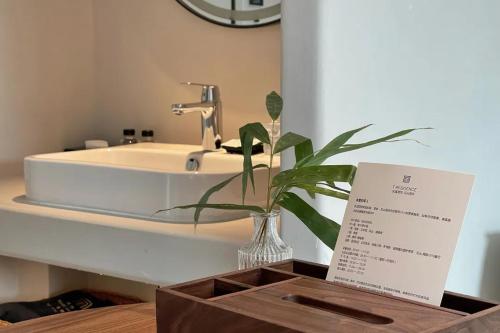 a bathroom with a sink and a mirror at Phoenix Hall House Hotel in Fenghuang