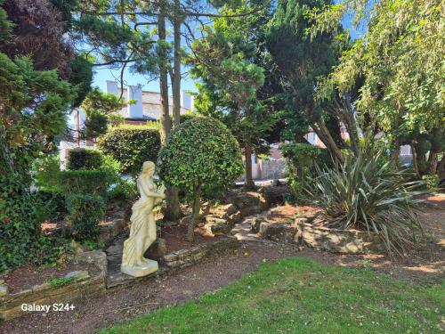 a statue of a woman in a garden at Trecarn Hotel in Torquay
