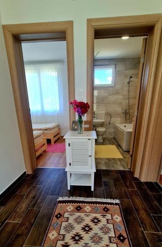 a bathroom with a vase of flowers on a table at Kosta's White House in Plav
