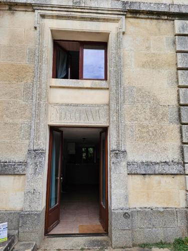 an entrance to a building with two windows at Château de la Court d'Aron in Saint-Cyr-en-Talmondais