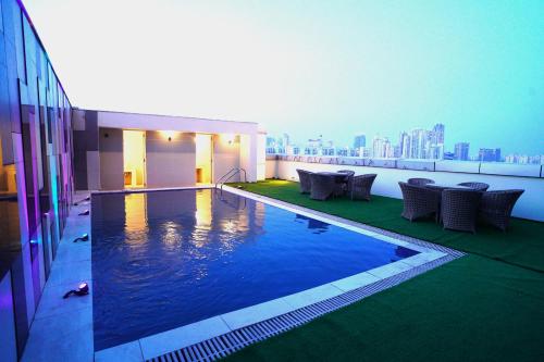 a swimming pool on the roof of a building at Hotel Sakura Gold in Gurgaon