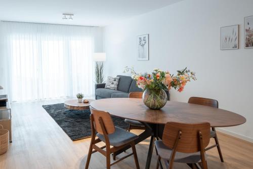 a living room with a table and a couch at SCHÖNTALHAUS City Apartments mit Balkon in Aschaffenburg