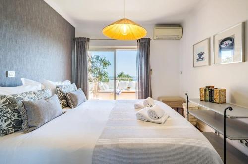 a bedroom with a large bed with towels on it at Luxury Sea View in Cascais