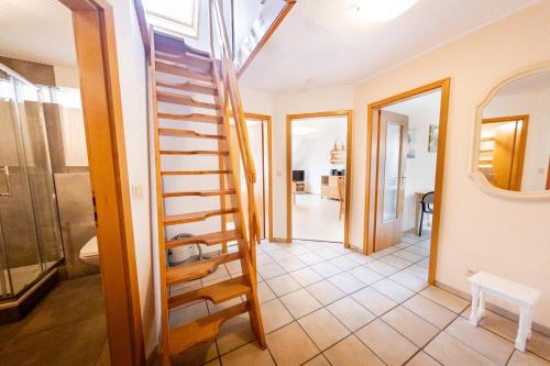 a hallway with a spiral staircase in a house at Gasthaus Deichkieker - Wo die Nordsee dich umarmt und Erholung beginnt in Horumersiel