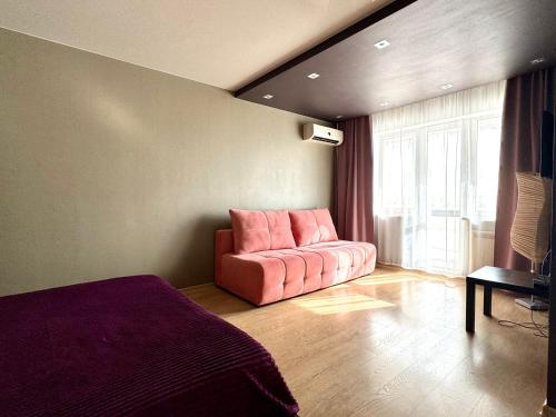 a living room with a pink couch in a room at Гоголя 68 in Karagandy