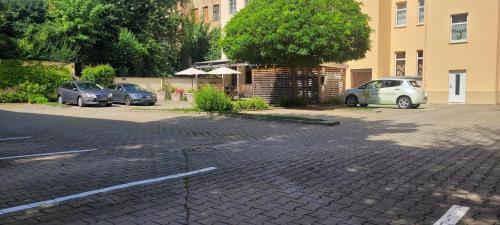 a parking lot with several cars parked in it at Hotel Via Regia - VIAs-Hotels in Görlitz