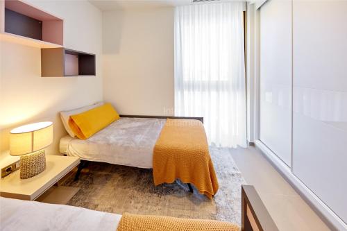 a small bedroom with a bed and a window at INTEMPO SKY Apartament-231 in Benidorm