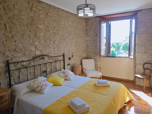 a bedroom with a large bed with towels on it at Ronda del Castillo in Olite