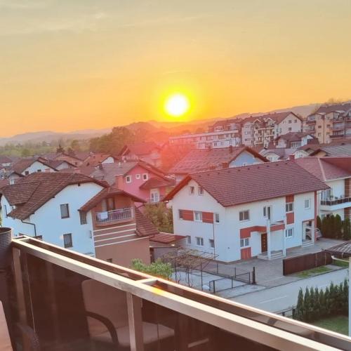 a view from a balcony of a town at sunset at Sunset in Teslić