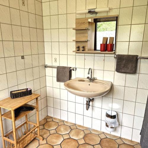 a bathroom with a sink and a mirror at Haus Scheuten Hotel in Duisburg
