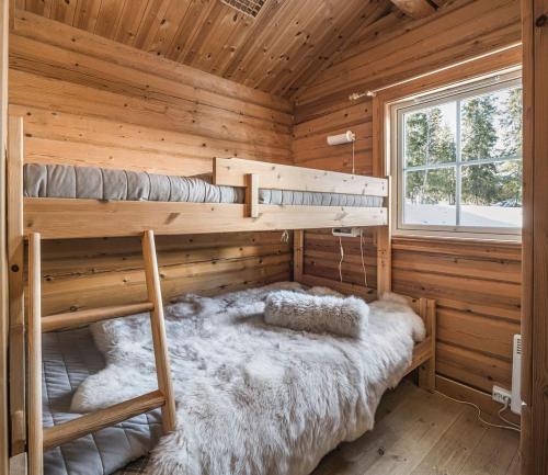 a bedroom with two bunk beds in a log cabin at Trysilfjellet Nord 356 C in Trysil
