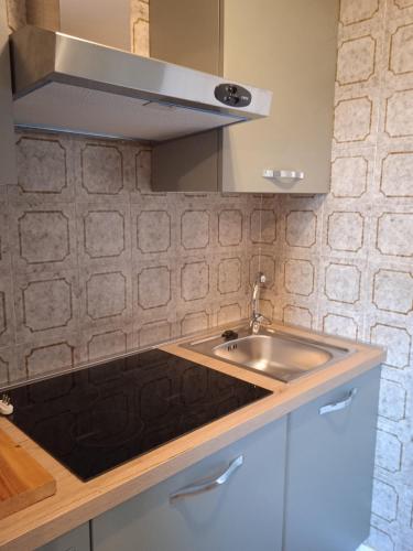 a kitchen with a sink and a microwave at Mountain Shelter in Passo del Tonale