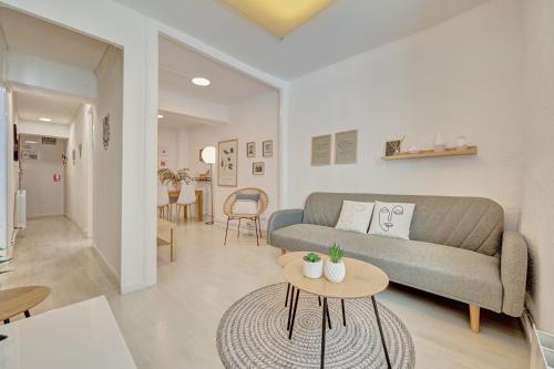 a living room with a couch and a table at Patio de Calderería by Clabao in Pamplona