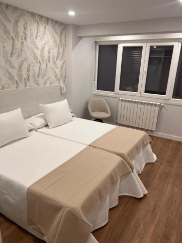 Postel nebo postele na pokoji v ubytování SLEEP Padron Turismo