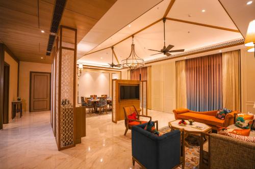 a living room with couches and a dining room at Taj Corbett Resort and Spa Uttarakhand in Rāmnagar