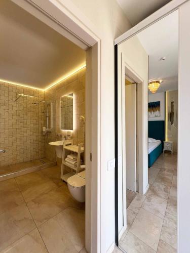 a bathroom with a toilet and a sink and a tub at Vila Ducu Mamaia Nord - Teens and Adults Only 14 and Over in Mamaia Sat/Năvodari