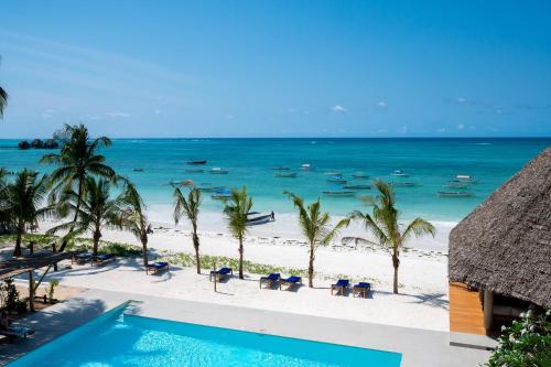 a view of the beach from a resort with a swimming pool at Ocean Boutique Hotel - Adults only in Pingwe