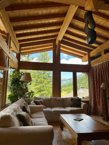 a living room with a couch and a table at Hôtel Le Jeu de Paume in Chamonix-Mont-Blanc