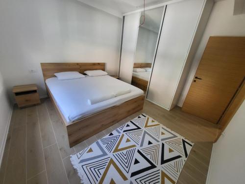 a small bedroom with a bed and a mirror at Herzegovina Dream Residence in Stolac