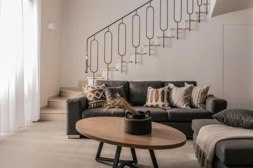 a living room with a couch and a table at Villa Cossoro Ena in Zakynthos in Xirokástellon