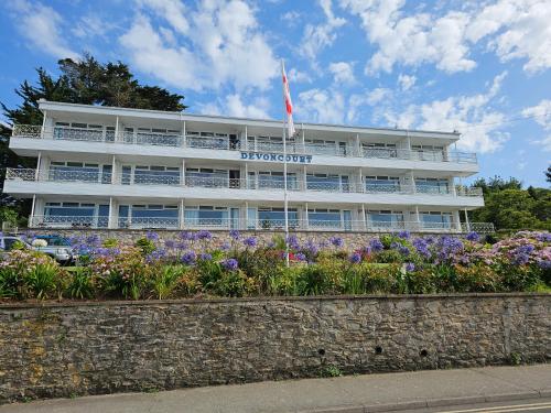 a building with flowers in front of it at Devoncourt Devoncoast SeaView Apartments in Brixham