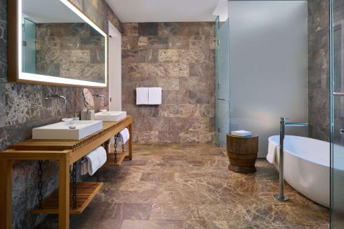 a bathroom with two sinks and a bath tub at Andaz Maui at Wailea Resort - A Concept by Hyatt in Wailea