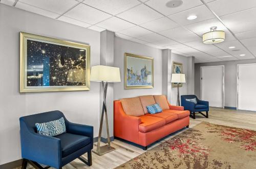 a waiting room with a couch and two chairs at Hampton Inn Chicago-Naperville in Naperville